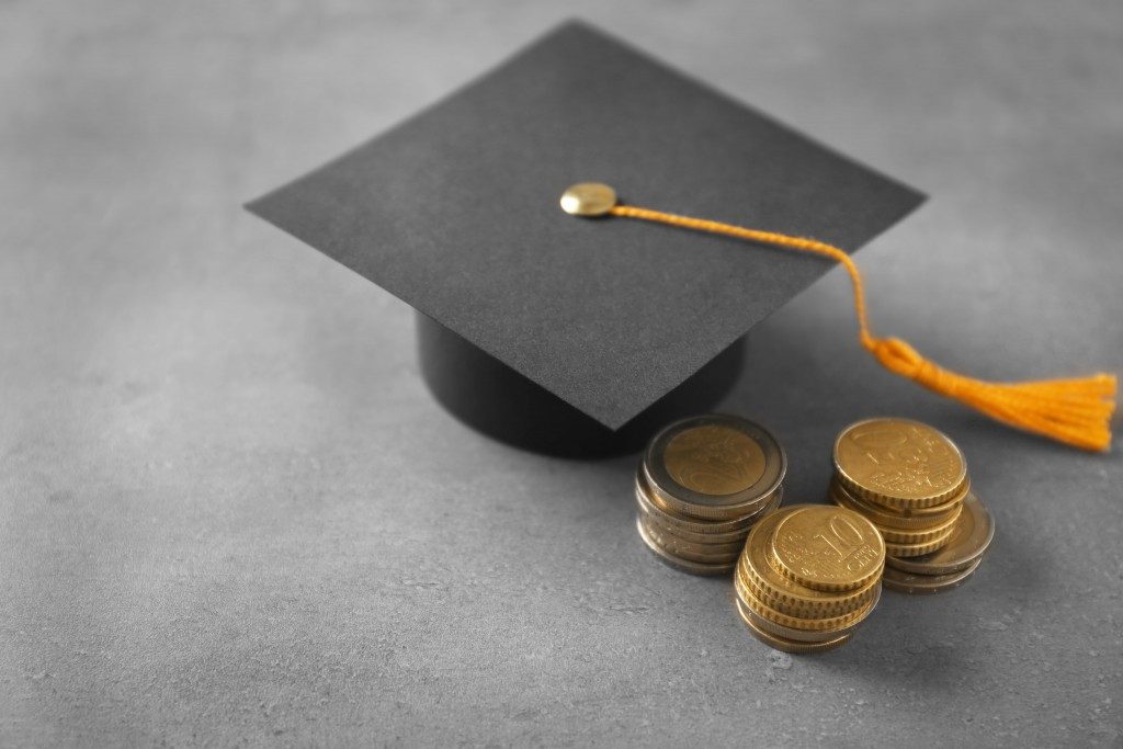 Graduation hat and coins on table
