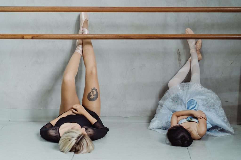 Ballerinas resting on floor in dance studio