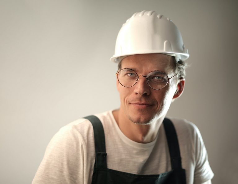 Male construction worker wearing a white hard hat