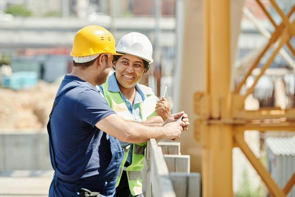 Two construction workers talking with each other